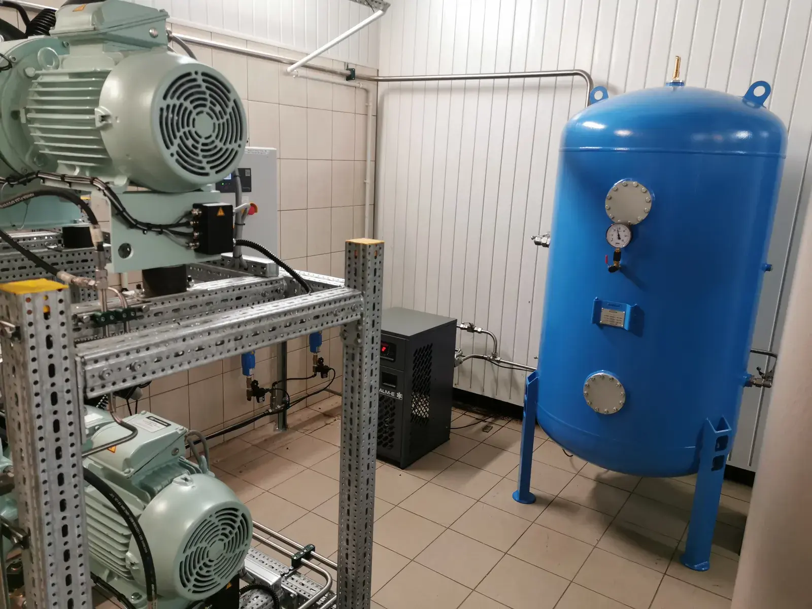 Compressor room at the Solina plant with the compressor set, air receiver and new stainless steel piping